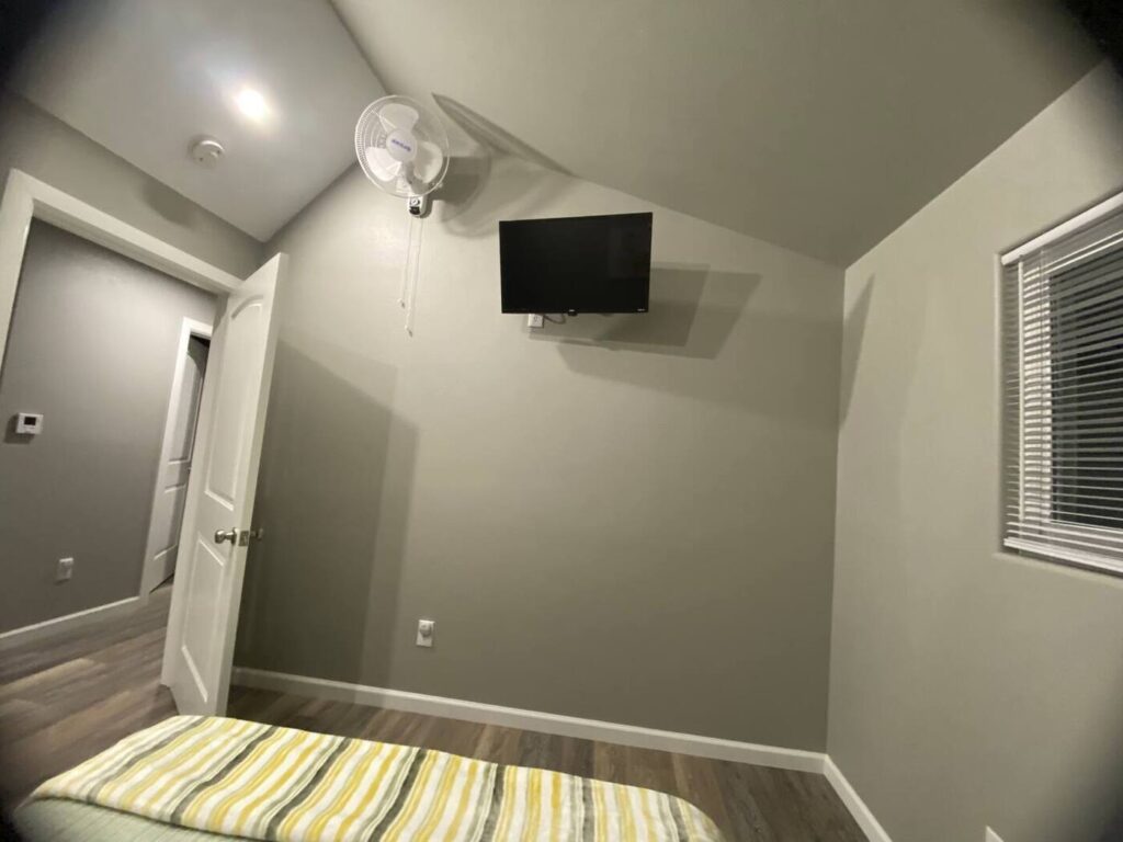 bedroom with tv on the wall