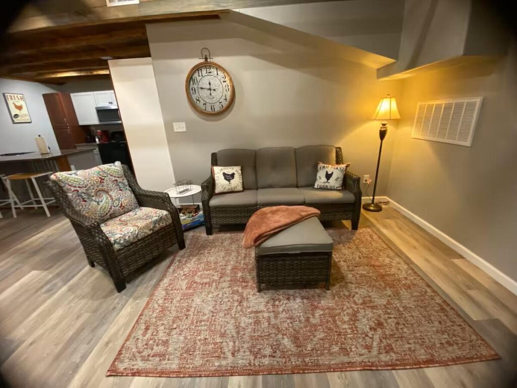 living area with sofa chair and ottoman