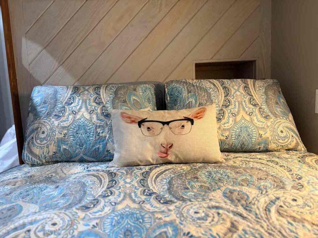 goat themed pillow on the bed